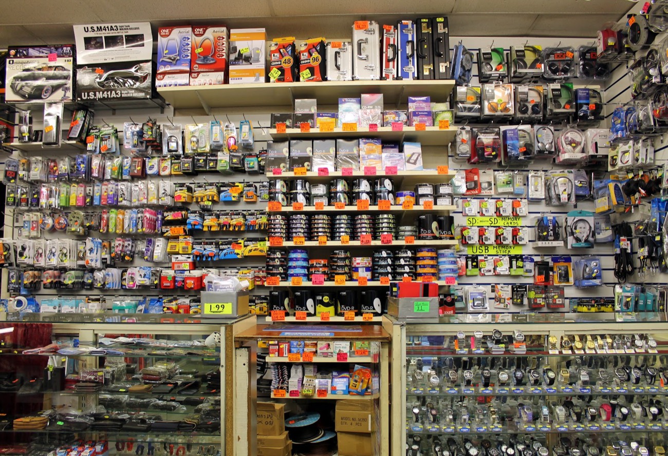 Walls of batteries, cables, USB sticks, headphones and small gadgets inside Raj Enterprises